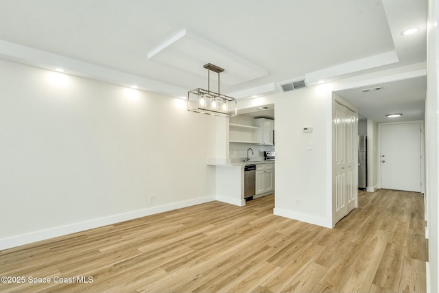 unfurnished living room with sink and light wood-type flooring