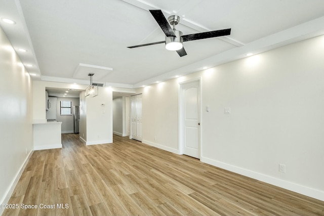 unfurnished room with ceiling fan, light hardwood / wood-style flooring, and beamed ceiling