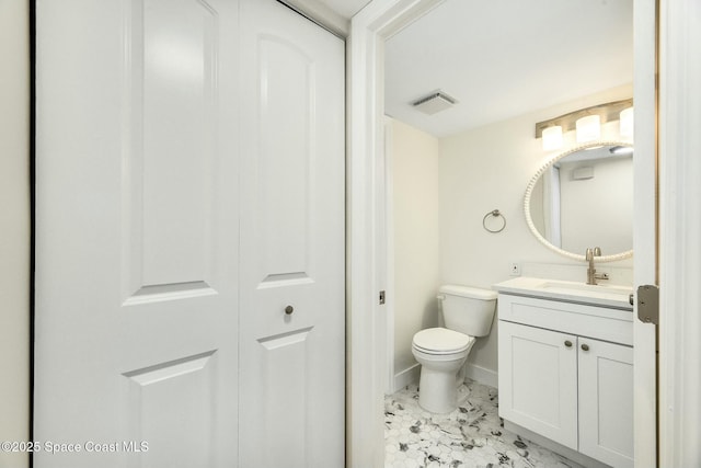 bathroom featuring toilet and vanity