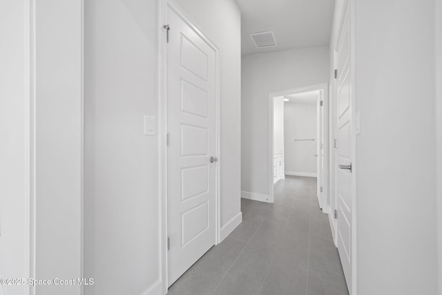 hall with light tile patterned floors