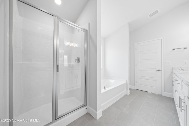 bathroom featuring independent shower and bath, tile patterned floors, and vanity