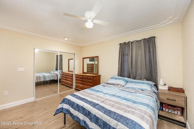 bedroom with hardwood / wood-style flooring, a closet, and ceiling fan