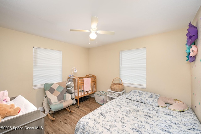 bedroom with light wood-type flooring and ceiling fan