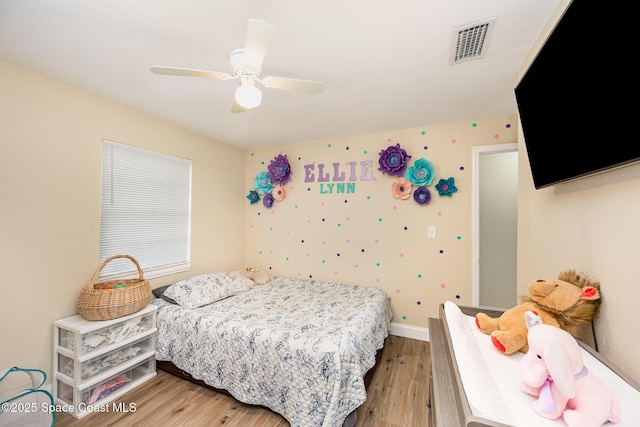 bedroom with ceiling fan and light wood-type flooring