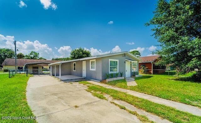 ranch-style home with a carport and a front lawn