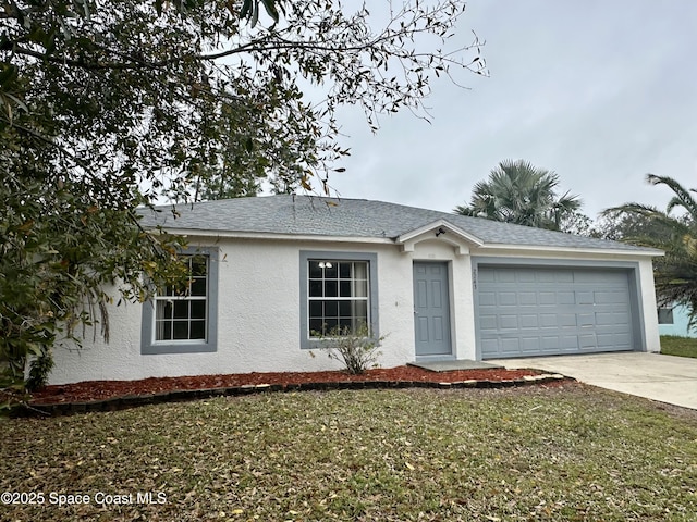 single story home with a garage and a front lawn