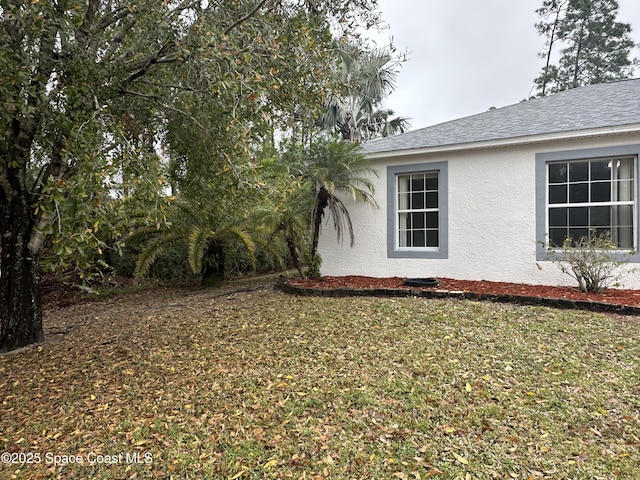 view of property exterior featuring a lawn