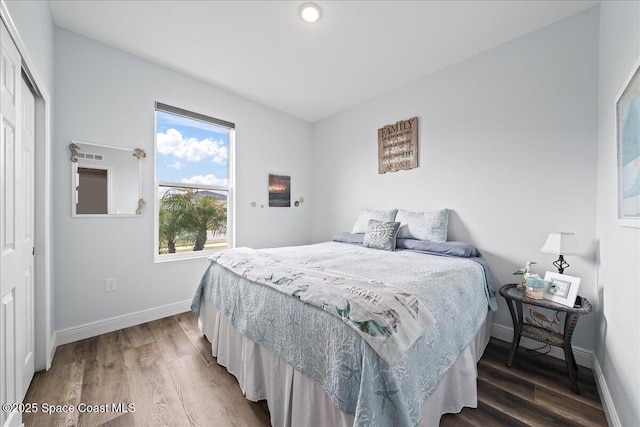 bedroom with a closet and dark hardwood / wood-style floors