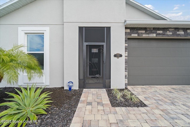 view of exterior entry with a garage