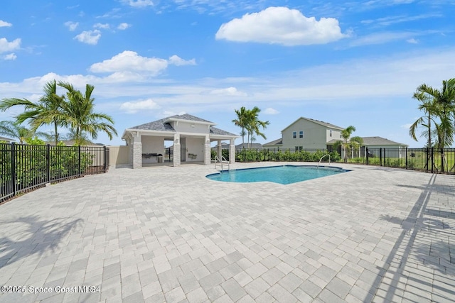 view of pool featuring area for grilling and a patio area