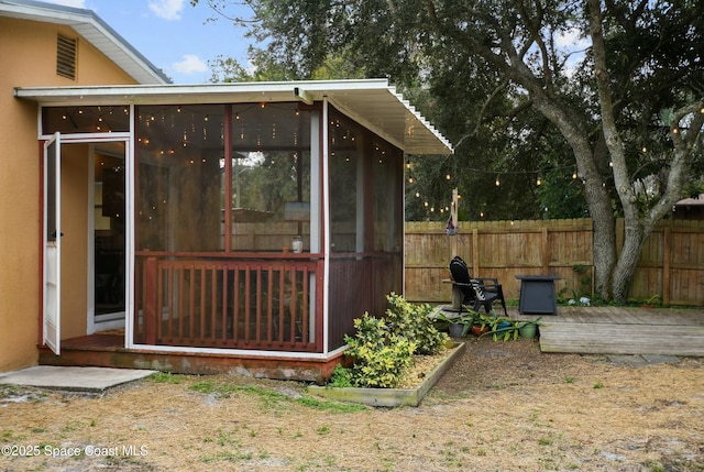 view of outdoor structure with a sunroom