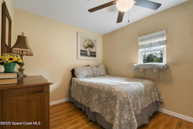 bedroom with ceiling fan and light hardwood / wood-style floors