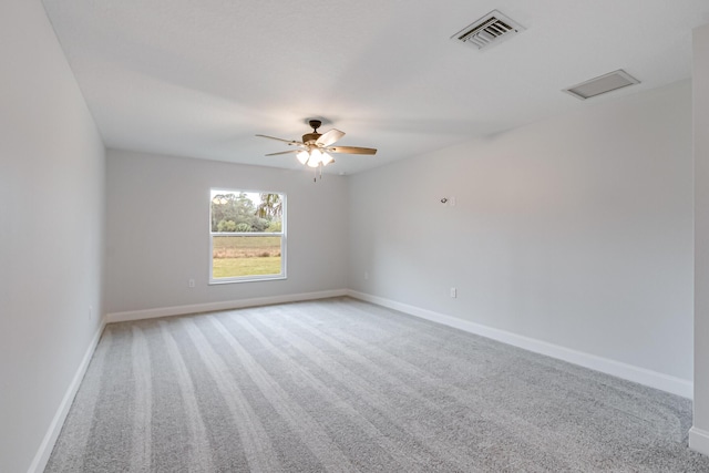 empty room with ceiling fan and carpet flooring