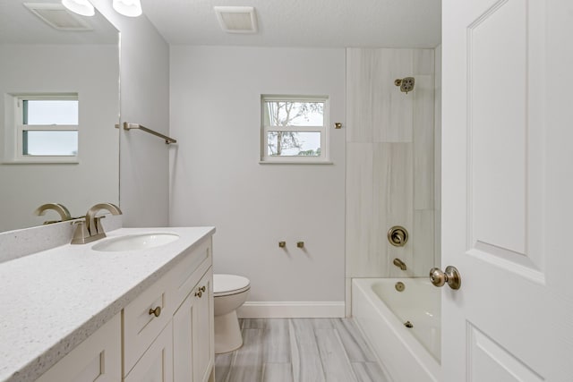 full bathroom with a wealth of natural light, toilet, vanity, and  shower combination