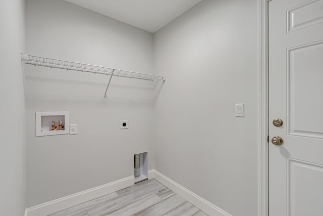 laundry room with hookup for a washing machine, hookup for an electric dryer, and light wood-type flooring