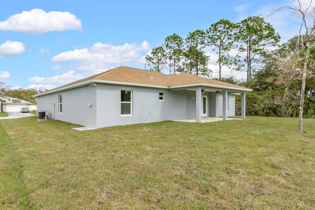 back of house with a lawn, a patio area, and central AC