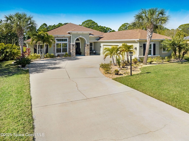 mediterranean / spanish-style house with a garage and a front lawn