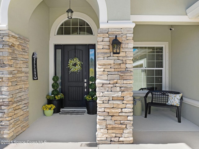 view of exterior entry featuring a wall mounted air conditioner