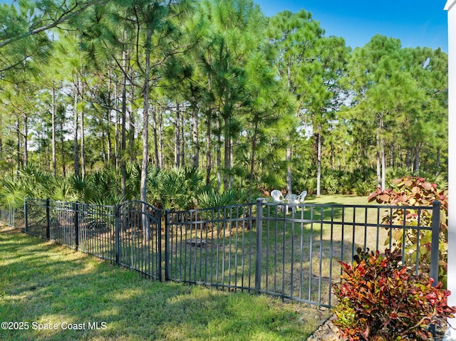 view of gate featuring a yard