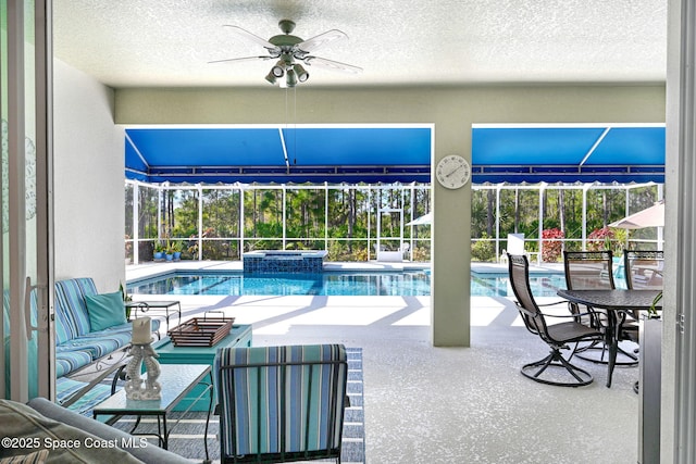 view of swimming pool with an in ground hot tub, ceiling fan, a lanai, and a patio