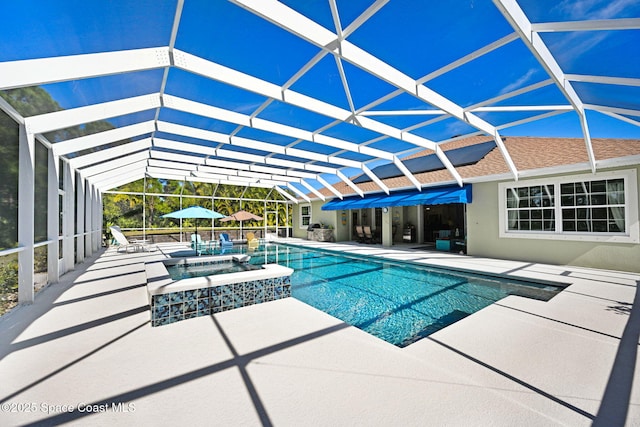 view of swimming pool with a patio area, glass enclosure, and an in ground hot tub