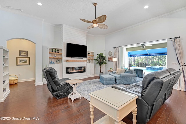 living room featuring crown molding, a textured ceiling, ceiling fan, and dark hardwood / wood-style flooring