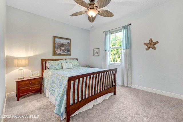 bedroom featuring light colored carpet and ceiling fan