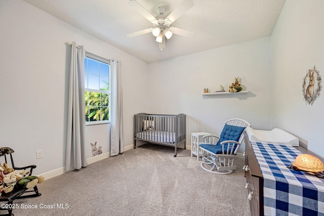 bedroom featuring ceiling fan, a textured ceiling, and carpet