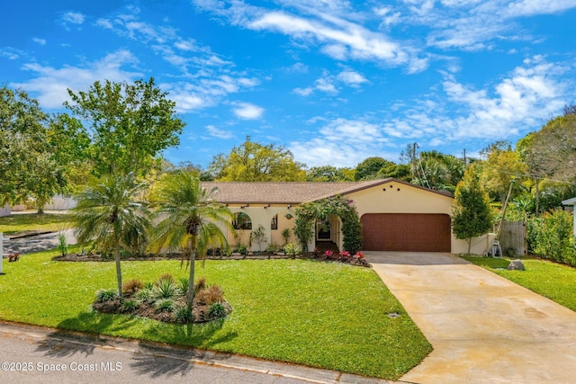 mediterranean / spanish-style house with driveway, a garage, a front lawn, and stucco siding