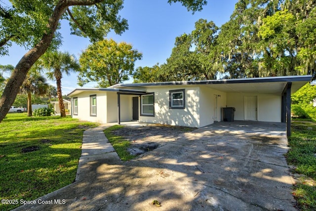 single story home with a carport and a front lawn