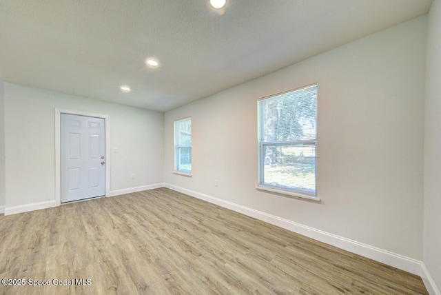 unfurnished room featuring light hardwood / wood-style floors