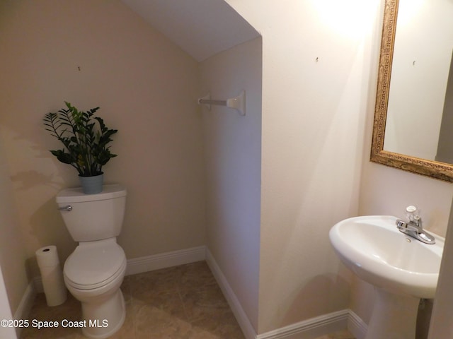 bathroom featuring tile patterned flooring, sink, and toilet