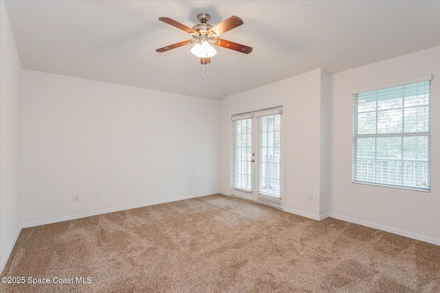 empty room with light carpet, ceiling fan, and french doors