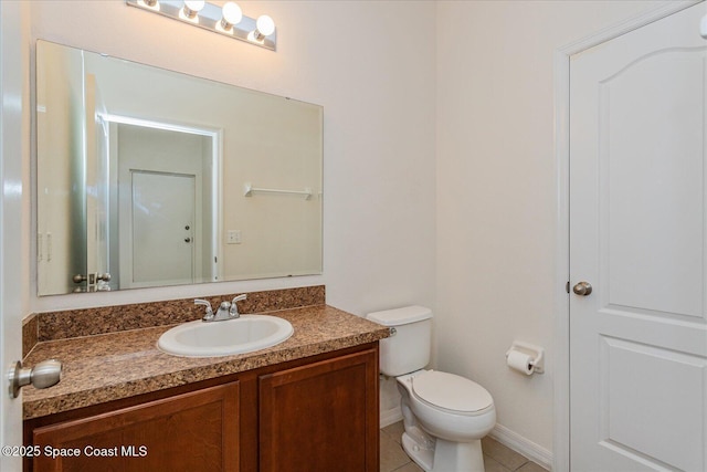 bathroom with toilet, tile patterned flooring, and vanity