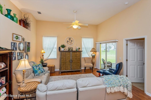 living room with hardwood / wood-style flooring and ceiling fan