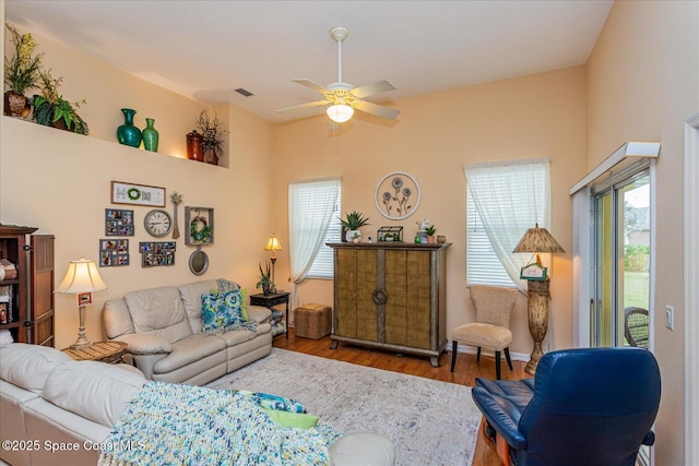 living room with ceiling fan and hardwood / wood-style floors