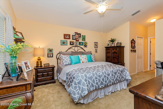 bedroom with ceiling fan, a closet, light carpet, and vaulted ceiling