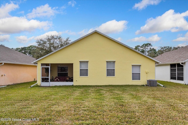 back of property featuring a sunroom, a yard, and cooling unit