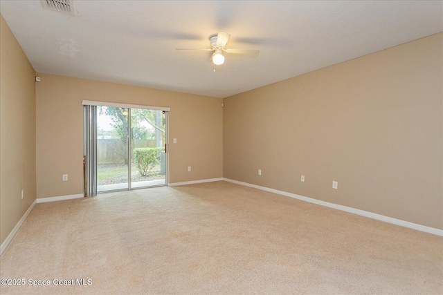 spare room featuring ceiling fan and light colored carpet