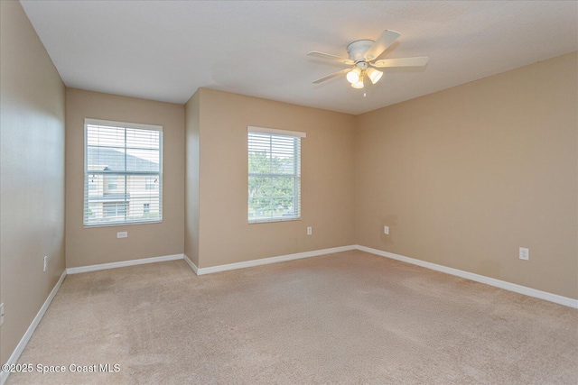 unfurnished room featuring ceiling fan and light colored carpet