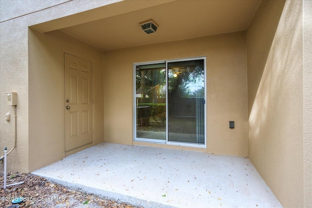 entrance to property featuring a patio area