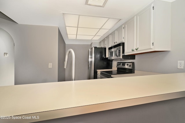 kitchen with white cabinets and appliances with stainless steel finishes