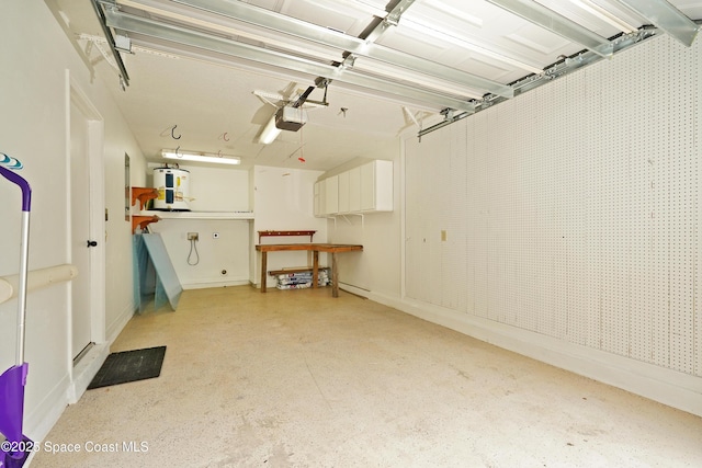 garage with water heater and a garage door opener