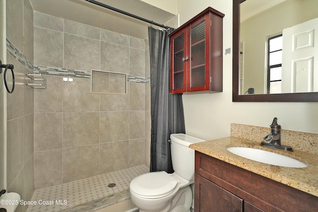 bathroom featuring vanity, toilet, and curtained shower