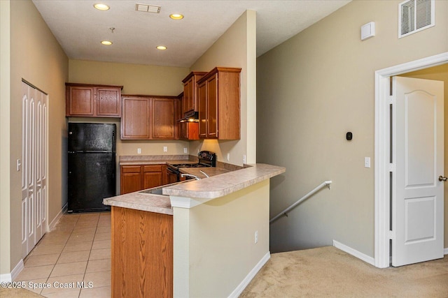 kitchen featuring sink, light tile patterned floors, black appliances, and kitchen peninsula