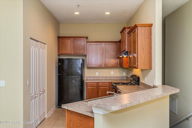 kitchen with black appliances, sink, a kitchen breakfast bar, kitchen peninsula, and light tile patterned floors