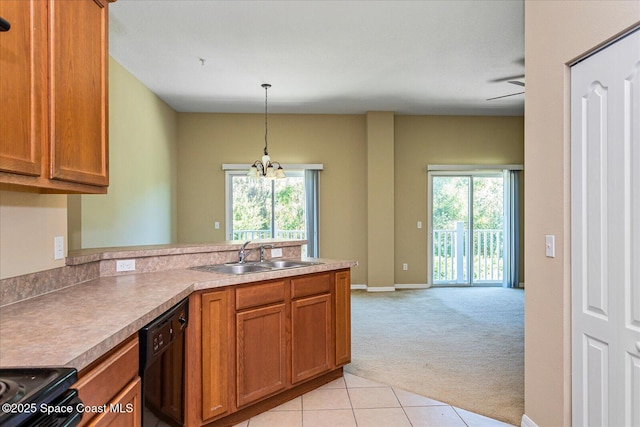 kitchen featuring sink, a wealth of natural light, light carpet, and hanging light fixtures