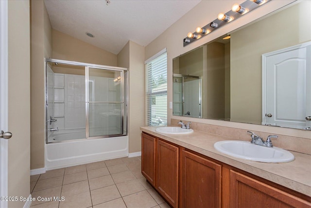 bathroom with vanity, shower / bath combination with glass door, vaulted ceiling, and tile patterned flooring