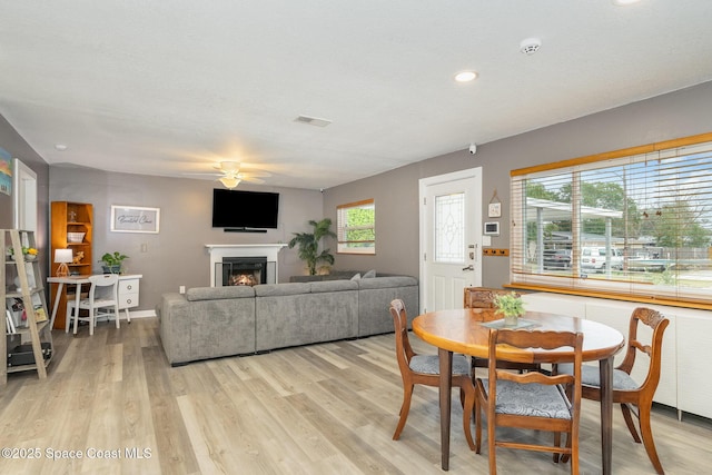 dining room with light wood-type flooring and ceiling fan