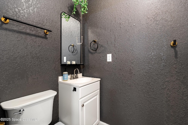 bathroom featuring toilet and vanity